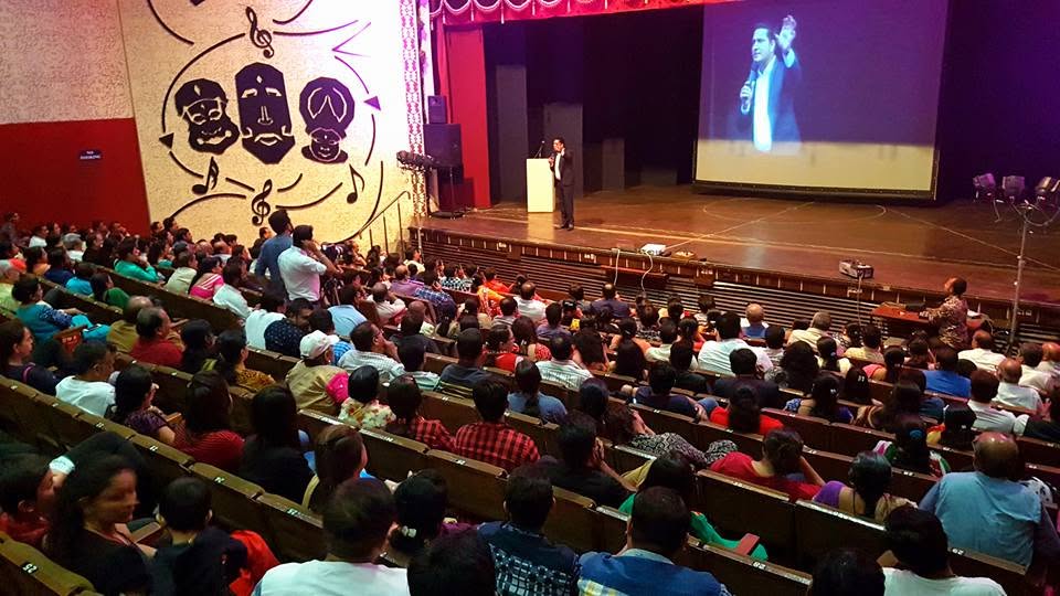 Parikshit Jobanputra parenting education session with a large stage projection