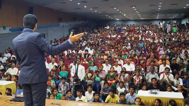 Parikshit Jobanputra speaking to a packed audience of Indian parents and children