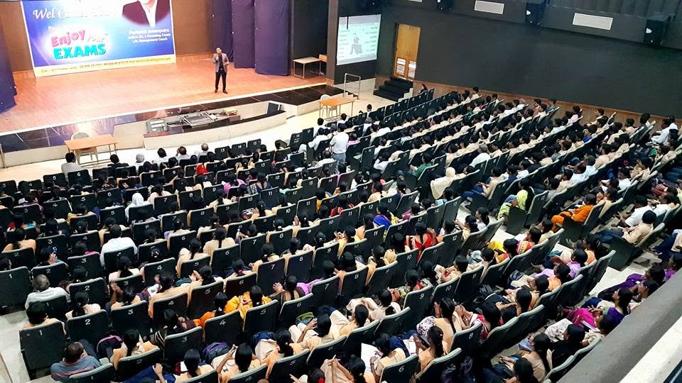 Parikshit Jobanputra parenting seminar with rows of participants facing the stage