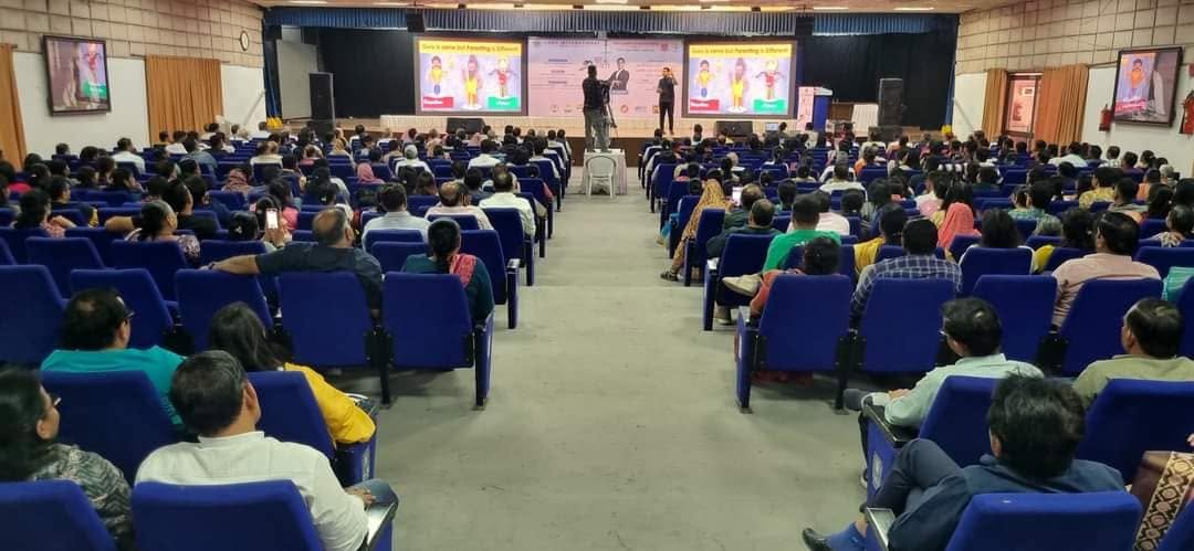 Parikshit Jobanputra parenting seminar with families seated in a large auditorium